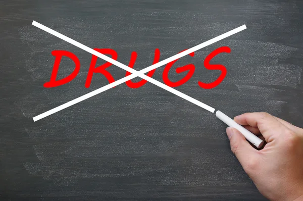 Say no to drugs - crossing out drugs on a smudged chalkboard — Stock Photo, Image