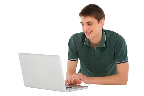 Adolescent garçon avec ordinateur portable couché — Photo