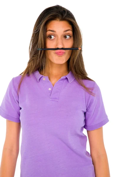 Tonårig flicka balansera penna på hennes läpp — Stockfoto