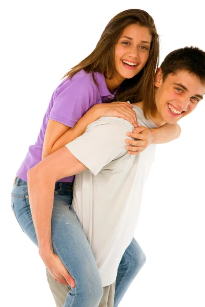 Tizenéves fiú piggybacking tizenéves lány — Stock Fotó