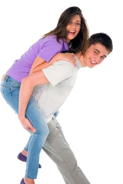 Tizenéves fiú piggybacking tizenéves lány — Stock Fotó