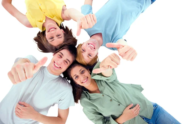 Teenagers lying down with thumbs up — Stock Photo, Image