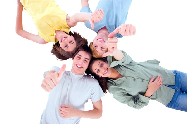Teenagers lying down with thumbs up Stock Picture