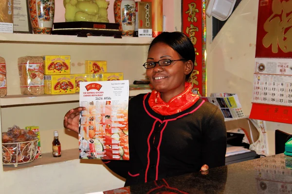 Chinese Restaurant African Receptionist Holding Menu