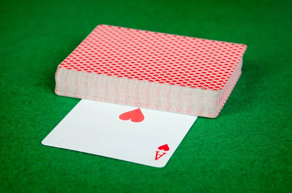 Deck of cards on green surface — Stock Photo, Image