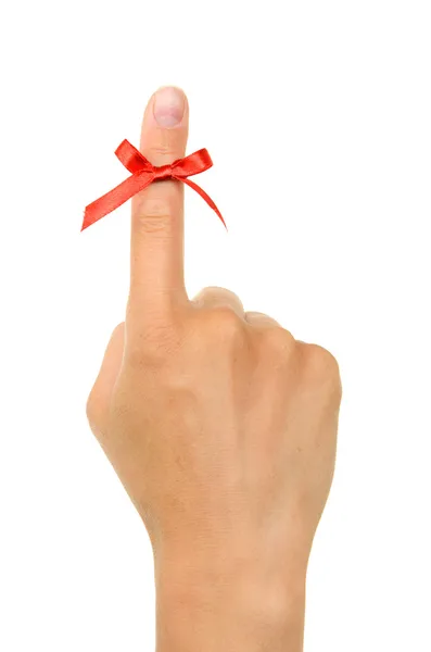 Red string tied around finger as a reminder — Stock Photo, Image