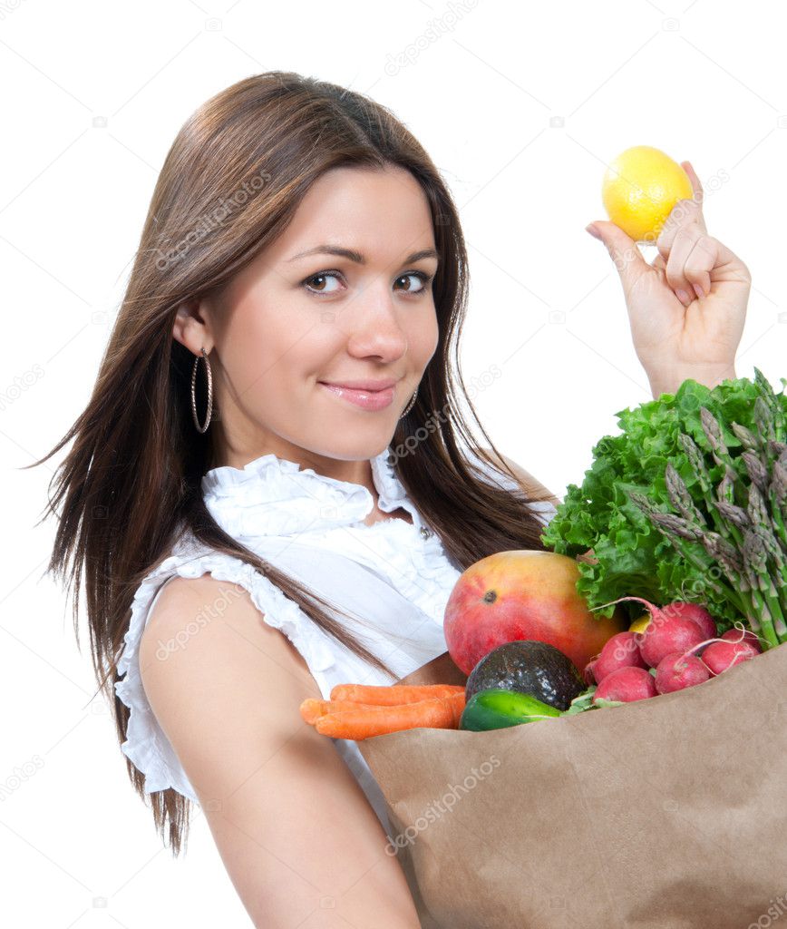 Woman holding a paper shopping bag full of groceries
