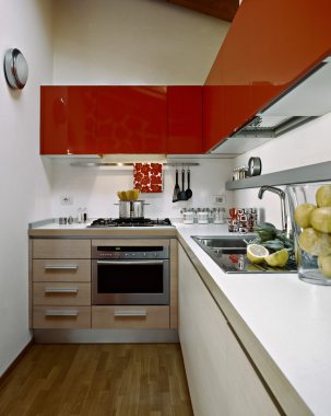 Modern kitchen with red kitchen cabinets clipart