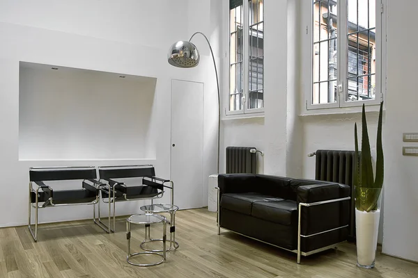 stock image Black leather sofa and armchairs in living room