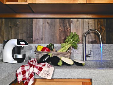 Vegetables near the faucet in the rustic kitchen clipart