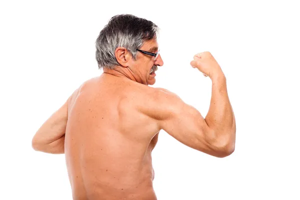 Active senior showing biceps — Stock Photo, Image
