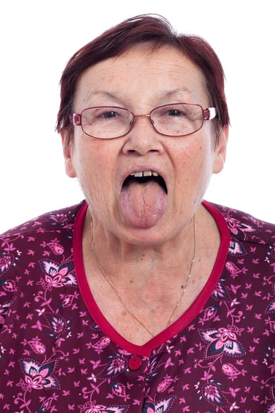 Senior woman sticking out tongue — Stock Photo, Image
