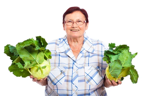 Счастливая пожилая женщина с кольраби — стоковое фото