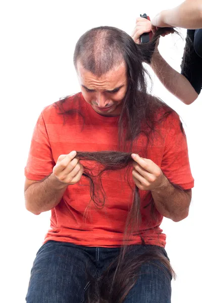 stock image Unhappy bald man holding his long hair