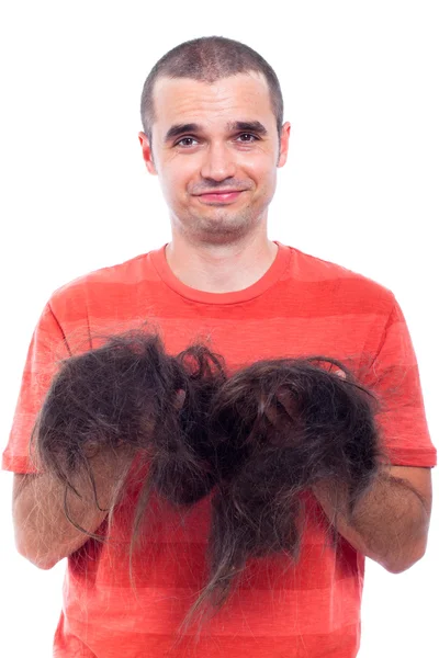 Łysy mężczyzna trzyma długo ogolone włosy — Zdjęcie stockowe