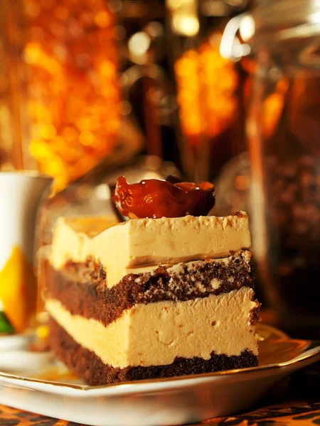 Vienna cake with almond and caramel at stained-glass window back — Stock Photo, Image