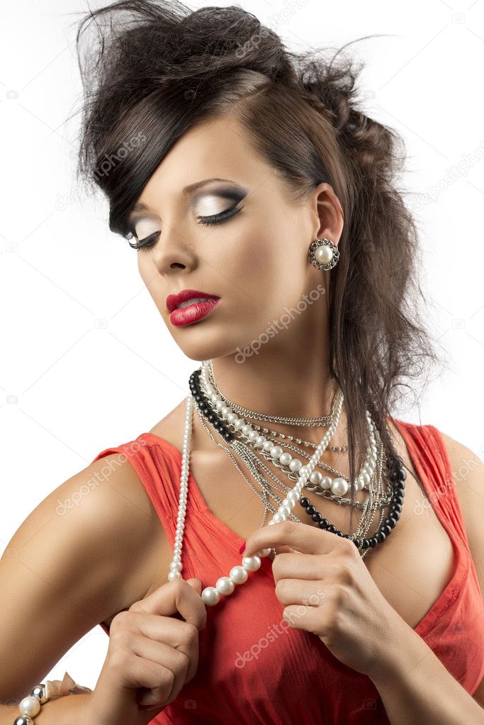 Portrait of fashion brunette that touches one necklace