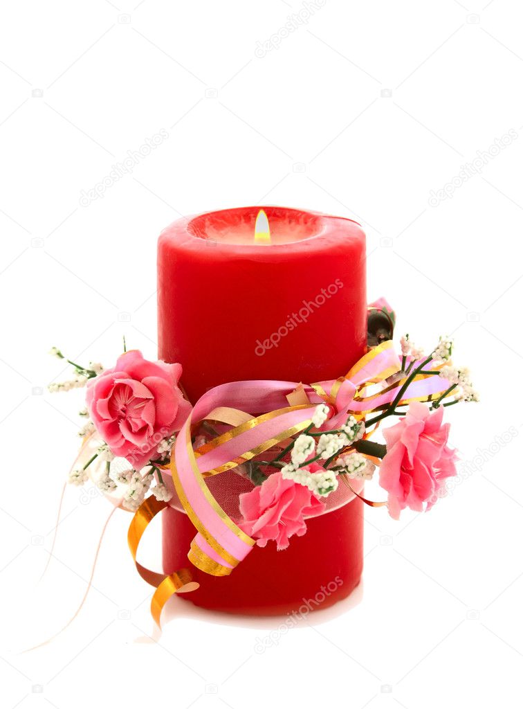 Candle decorated with artificial flowers