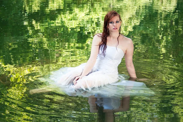 Woman appearing to float in green water — Stock Photo, Image