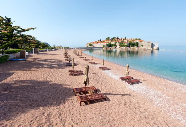 stock image Sveti Stefan sea islet morning view with sandy beach (Montenegro