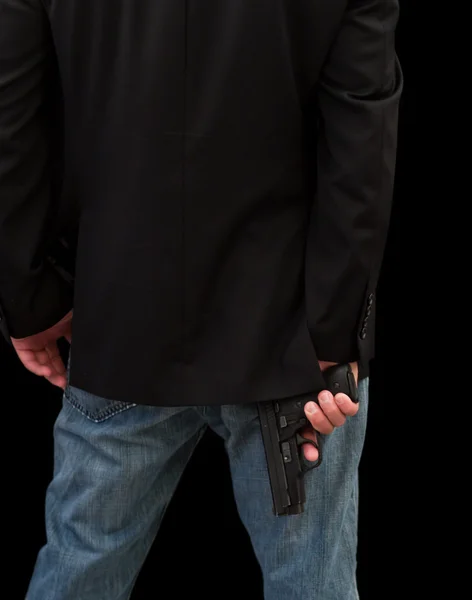 Egy fegyveres öltönyös férfi. — Stock Fotó