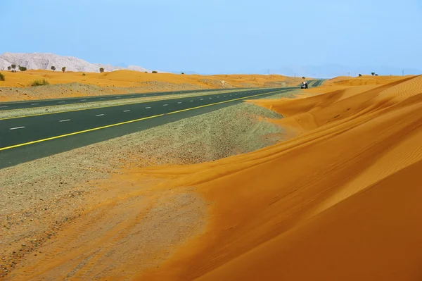 stock image Street that crosses the desert in Dubai