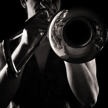 Man playing a trombone; strong contrasting side-light; monochrome version; clipart