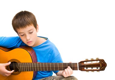 Caucasian boy learning to play acoustic guitar, isolated on white background; horizontal crop clipart