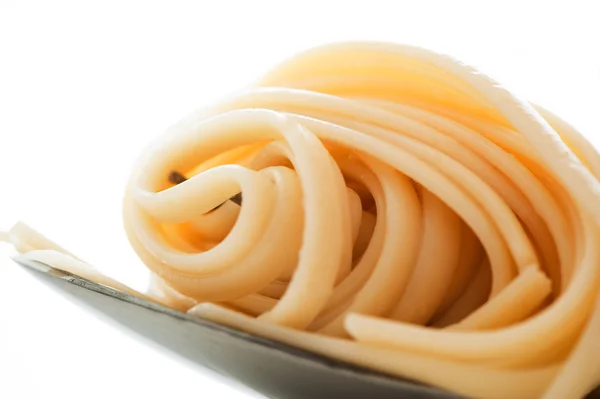 Spaghetti twirled around a fork on white background — Stock Photo, Image