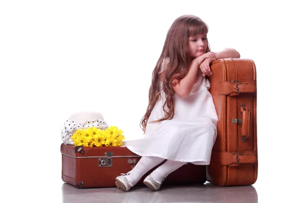 Charming girl on the suitcase — Stock Photo, Image