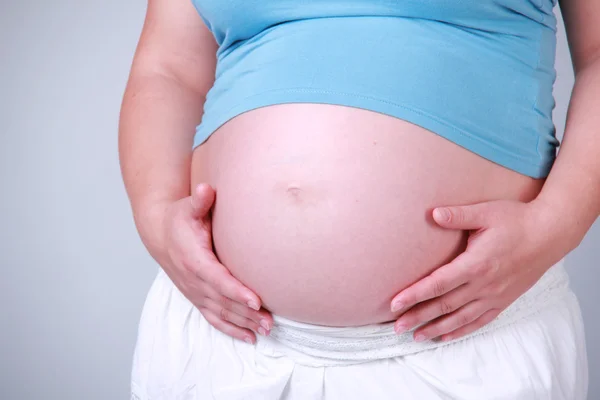 Studio image of body parts of pregnant woman Stock Photo
