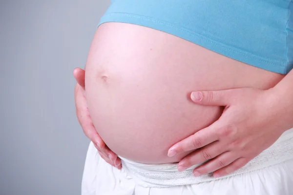Studio image of body parts of pregnant woman Stock Image