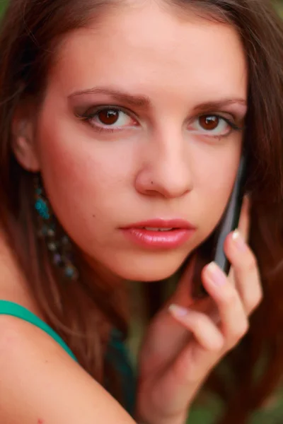 Güzel bir genç kadın görüşmeler tarafından cep telefonu açık — Stok fotoğraf