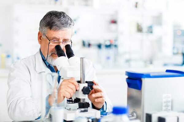 Senior male researcher carrying out scientific research in a lab