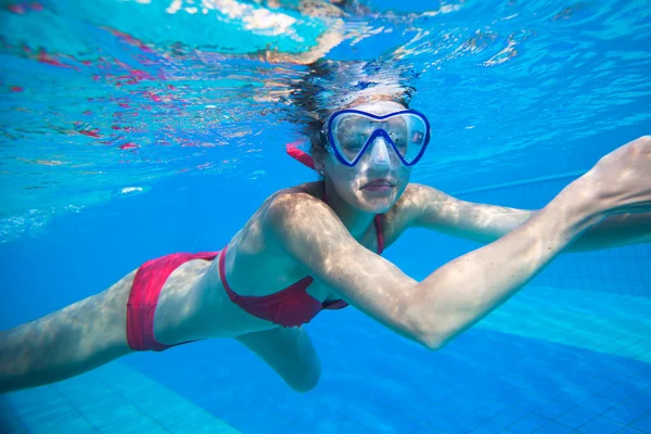 Nage sous-marine : jeune femme nageant sous l'eau dans une piscine — Photo