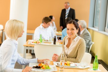 Cafeteria lunch young business women eat salad clipart