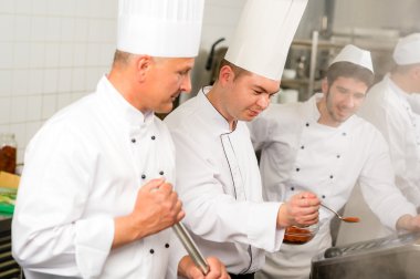 Two male cook work in professional kitchen clipart