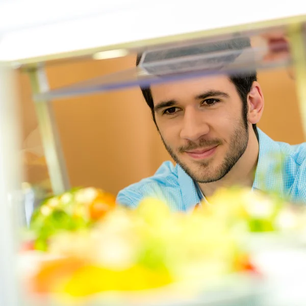 Cafeteria food display young man choose salad — Stock Photo, Image