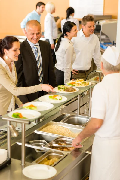 Compañeros de negocios cocinan sirven comida en la cantina —  Fotos de Stock