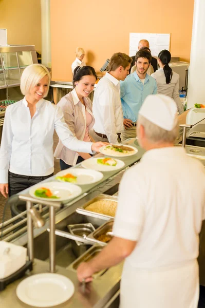 Geschäftskollegen kochen und servieren Mensa-Essen — Stockfoto