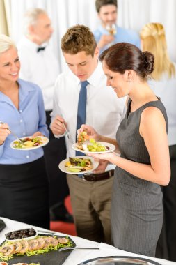 Business colleagues eat buffet appetizers clipart