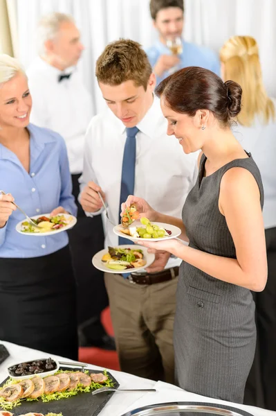 ビジネス部門の同僚は、ビュッフェ式の前菜を食べる — ストック写真