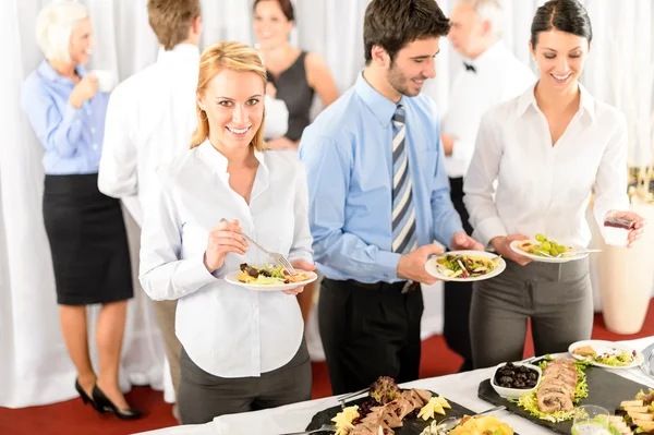 Business colleagues serve themselves at buffet Royalty Free Stock Photos