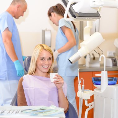 Smiling patient at dentist surgery clipart