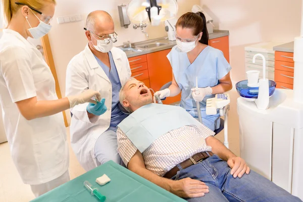 Senior man at dentist surgery have treatment — Stock Photo, Image