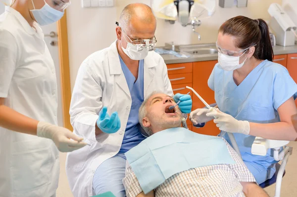 Senior man at dentist surgery have operation — Stock Photo, Image