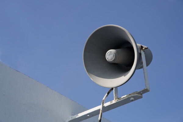 Isolated megaphone making loud noise at day