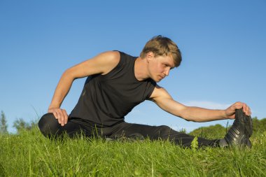 Sportsman is stretching foot blade for elastic clipart