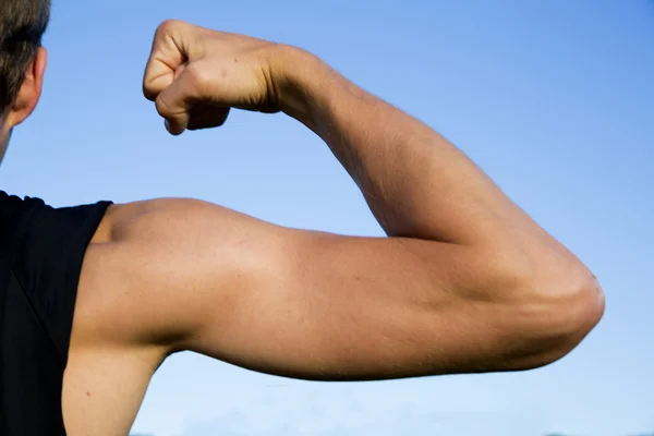 スポーツマンは、その筋肉を示すとき手のひずみ — ストック写真