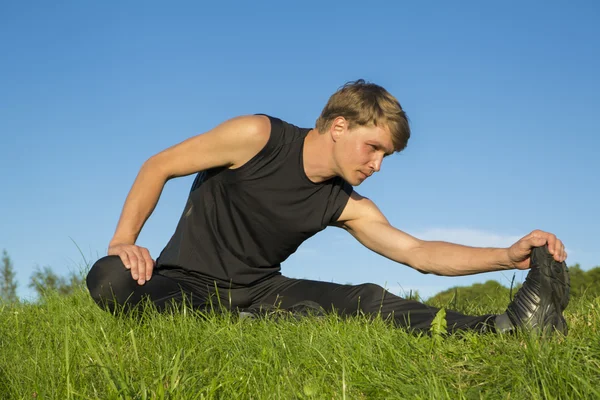 Sportsman is stretching foot blade for elastic — Stock Photo, Image